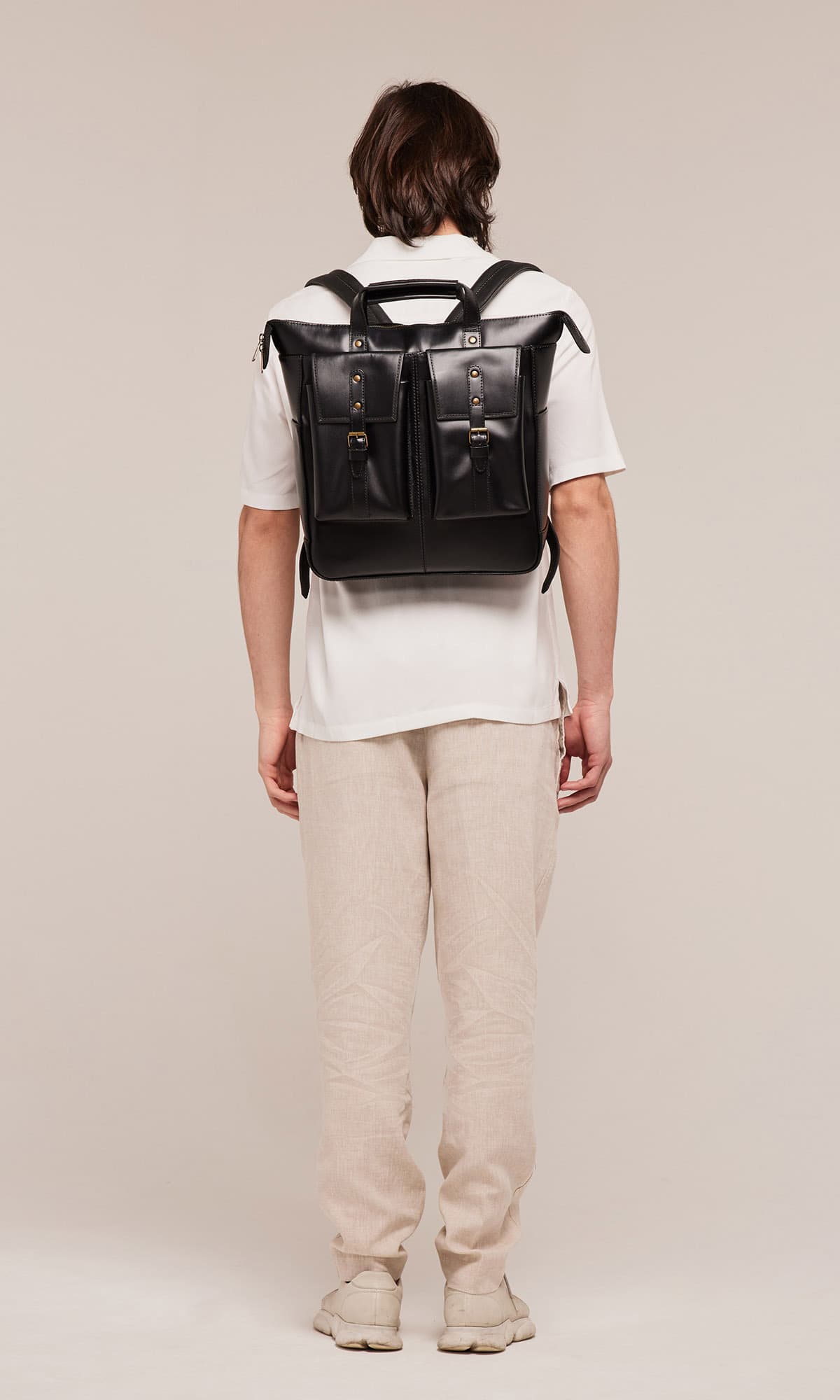 Close up of padded shoulder straps on Murphy Large black backpack showing comfort focused ergonomic leather design