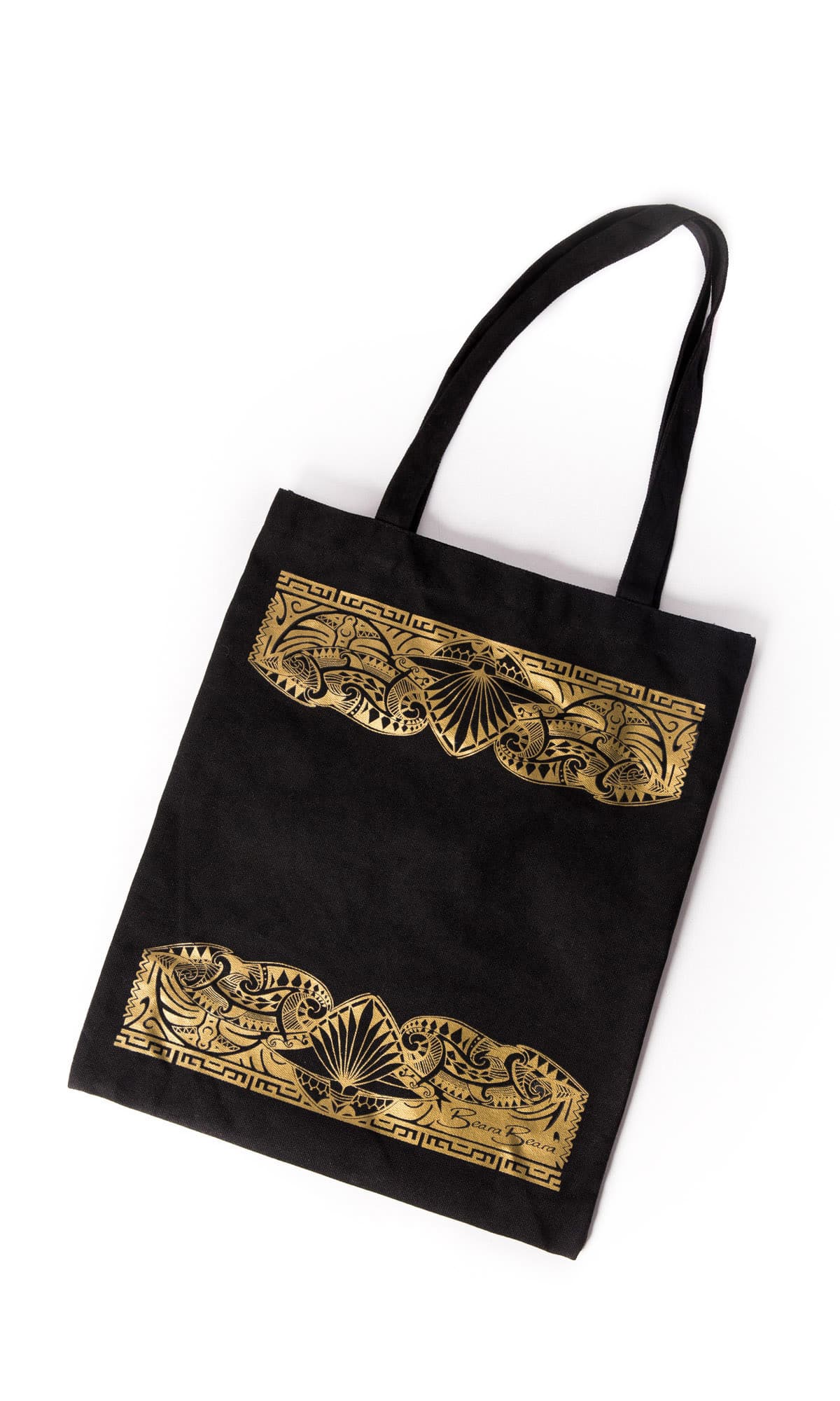 Person carrying the Beara Beara black canvas tote bag over one shoulder, used as an everyday carry-all